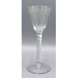 An Early Engraved Air Twist Cordial Glass decorated with flowers, 16 cms tall