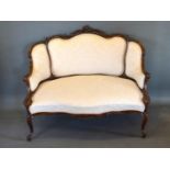 A Late 19th Early 20th Century French Mahogany Salon Sofa, the shaped carved and upholstered back