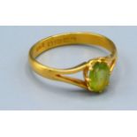 A 22ct. Gold Ring set oval peridot within a pierced setting, 4 gms. ring size T