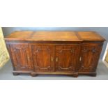 A 20th Century Mahogany Break Front Sideboard, the crossbanded and moulded top above a blind