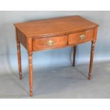 A 19th Century Mahogany Bow Fronted Side Table, the reeded top above two frieze drawers with oval