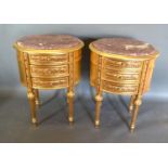 A Pair of French Style Oval Gilded Three Drawer Chests, the rouge marble tops above three carved