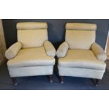 A Pair of Victorian Re-Upholstered Armchairs with turned tapering legs