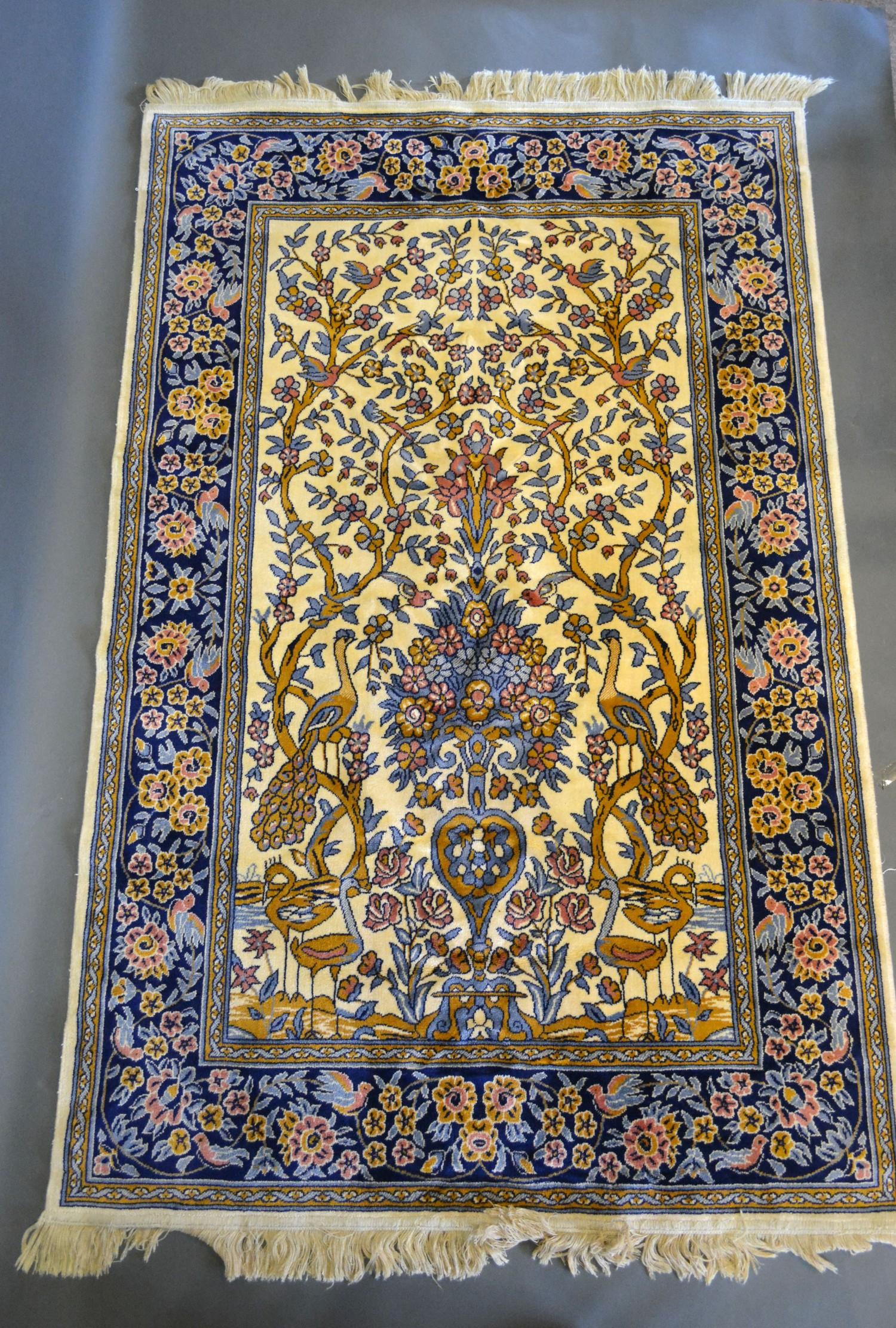 A Sarook Kashan Silk Rug of pictorial form decorated with exotic birds amongst foliage within