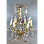 A Brass and Cut Glass Six Branch Chandelier with cut glass drops, 55 cms tall