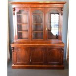 A Victorian Mahogany Library Bookcase, the moulded cornice above three glazed doors enclosing