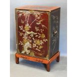 A Chinese Lacquered Cabinet on Stand, the two doors enclosing shelves upon a low hardwood stand with