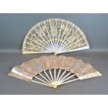A 19th Century Mother of Pearl and Lace Work Fan together with a similar 19th Century paper leaf fan