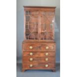 A Regency Mahogany Secretaire Bookcase, the moulded cornice above two astragal glazed doors