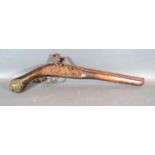 A 19th Century Middle Eastern Flintlock Pistol, with metal mounts, 49cms long