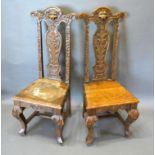 A Pair of Victorian Carved Oak Side Chairs the high backs with lion masks above panel seats raised