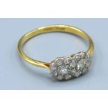 An 18ct. Gold and Platinum Double Diamond Cluster Ring, 2.6 gms. ring size T