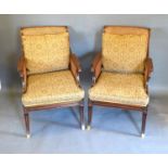 A Pair of Regency Style Mahogany Library Armchairs, the cane backs above padded seats with caned