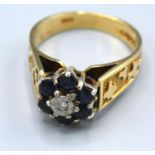 A 9ct. Gold Diamond and Sapphire Cluster Ring with a central diamond surrounded by sapphires, 4.5