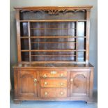 A George III Oak Dresser, the moulded cornice and boarded shelf back above a lower section with