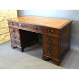 A Reproduction Mahogany Twin Pedestal Desk, the tooled leather inset top above nine drawers with