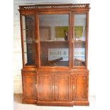 A 20th Century Mahogany Break Front Bookcase, the moulded cornice with pierced gallery above three