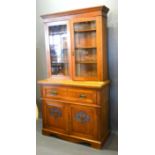 An Arts and Crafts Oak Secretaire Bookcase, the moulded cornice above two glazed doors enclosing