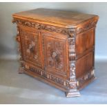 A Victorian Oak Side Cabinet, the moulded top above a mask head frieze drawer and two