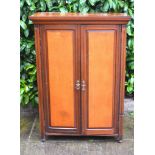 A Late Victorian Mahogany and Satinwood Side Cabinet, the moulded cornice above two panel doors