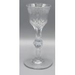 A Fine Cut Stem Wine Glass engraved with flowers, 15 cms tall