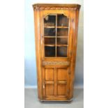 A 20th Century Green Oak Standing Corner Cabinet in the 18th Century style, the moulded cornice