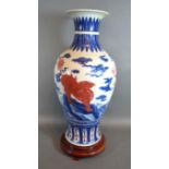 A Chinese Porcelain Oviform Vase decorated with iron red Fu dogs with underglaze blue six