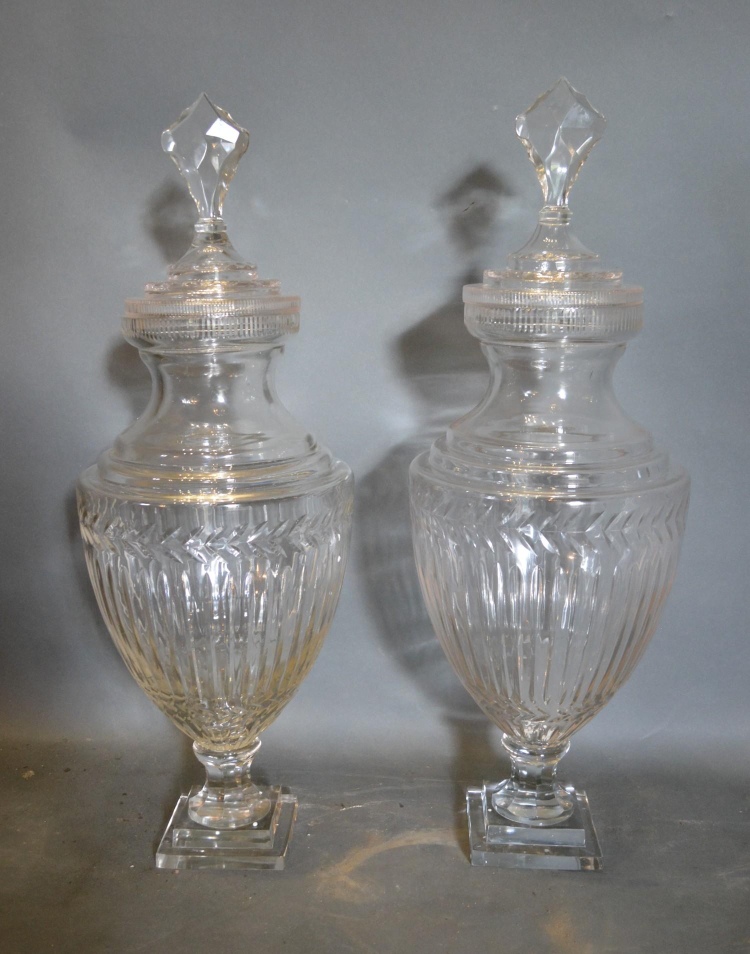 A Pair of Large Cut Glass Oviform Covered Vases of Ribbed form with square stepped bases, 70cm tall
