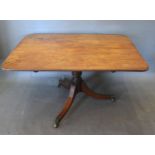 A 19th Century Mahogany Breakfast Table, the rectangular reeded top above a turned centre column and