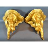 A Pair of French Carved and Gilded Wall Brackets each in the form of Putti, 32cms tall