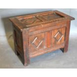 A Small Oak Coffer, the hinged top above a two panel front flanked by stiles 59 cms wide x 32 cms