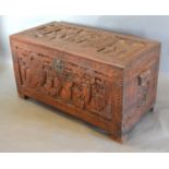 An Oriental Carved Chest with hinged top raised upon carved low feet with end handles, all profusely