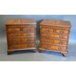 A Pair of Mahogany Small Chests, the moulded crossbanded inlaid tops above a brushing slide and