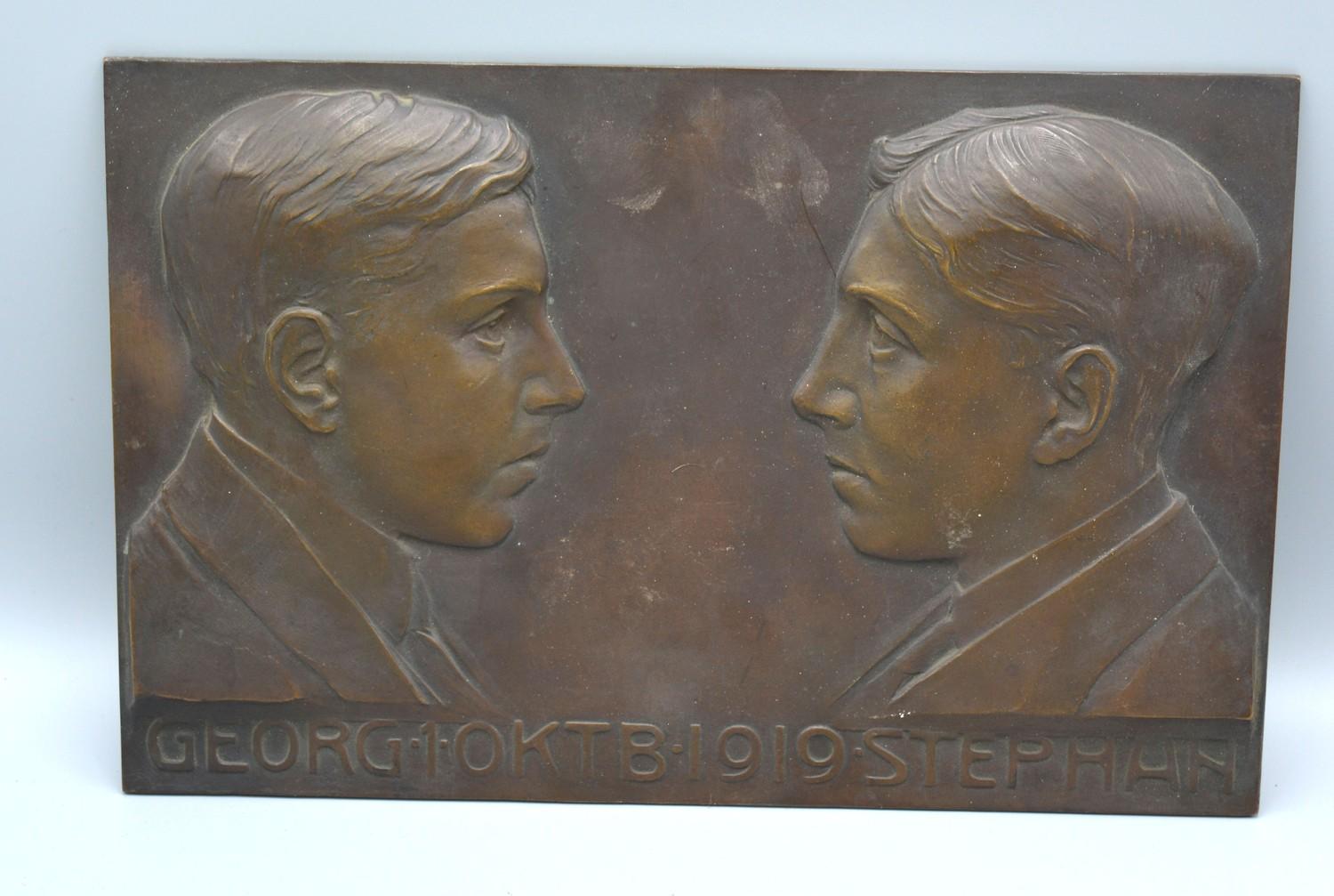 An Early 19th Century Patinated Bronze Plaque decorated in relief with two busts bearing scripts