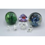 An Isle of Wight Glass Paperweight with two other paperweights together with four Swarovski models