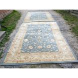 A Pair of Ziegler Turkish Machine Made Rugs with all over design within multiple borders upon a