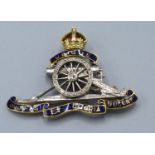 An 18ct. Gold Royal Artillery Brooch set with blue enamel and diamonds, 9.9 gms.
