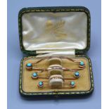 A Set of Three Yellow Metal and Turquoise Set Tie Clips within fitted case