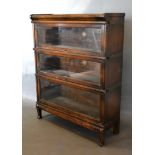 An Early 20th Century Oak Globe Wernicke Three Section Glazed Bookcase raised upon shaped feet,