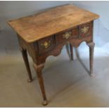 A George III Oak Low Boy, the moulded top above three frieze drawers with brass handles and shaped