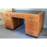 An Art Deco Mahogany Pedestal Desk by H. Baldock & Sons Ltd. the leather inset top above three