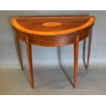 A George III Mahogany and Satinwood Inlaid Demi-Lune Card Table, the shell crossbanded inlaid top
