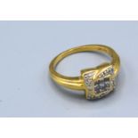 An 18ct. Gold Diamond Cluster Ring of Square Form with a central diamond surrounded by diamonds, 4.6