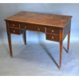 An Edwardian Mahogany Writing Desk, the moulded top above four moulded drawers with brass circular