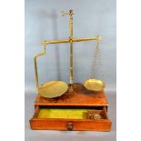 A Pair of Victorian Brass Balance Scales with mahogany box base with drawer and weights by W & T