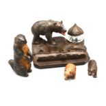 A Black Forest Carved Wooden Inkwell surmounted with a bear together with two other similar Black