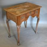 A George III Oak Low Boy, the moulded top above three frieze drawers with brass handles and shaped