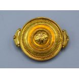 A Victorian Yellow Metal Brooch of circular form with locket back, 4.5 x 3.5 cms 12.7 gms all in