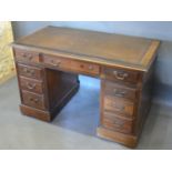 An Early 20th Century Mahogany Twin Pedestal Desk with nine drawers with brass handles raised upon