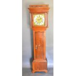 A George III Long Case Clock, the square hood with turned pilasters above a star inlaid door